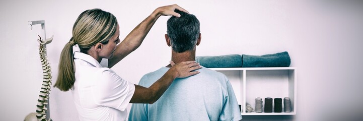 Doctor examining patient neck