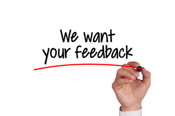 Human hand writing WE WANT YOUR FEEDBACK on whiteboard