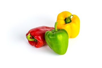 Yellow green and red bell sweet pepper with white background.