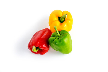 Yellow green and red bell sweet pepper with white background.