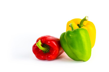 Yellow green and red bell sweet pepper with white background.