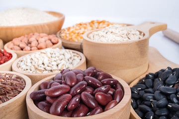 Cereal grains , seeds, beans on wooden background