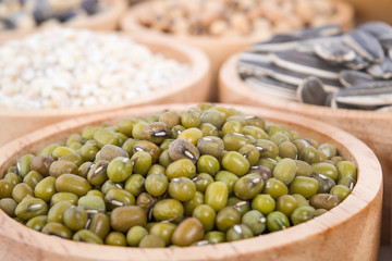 Cereal grains , seeds, beans on wooden background