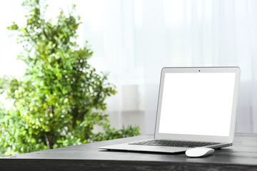 Fototapeta premium Laptop on desk in home office. Comfortable workplace