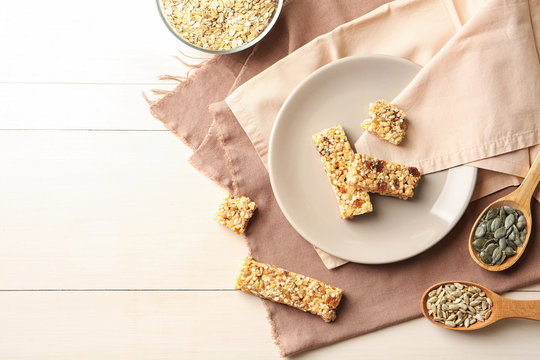 Flat lay composition with grain cereal bars on table. Healthy snack
