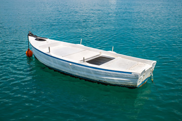 Fototapeta na wymiar small Fishing Boat on shore of Lagoon. Greece