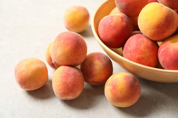 Many delicious ripe peaches on table, closeup