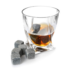 Glass with liquor and whiskey stones on white background