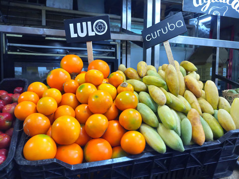 Lulo (Fortunella margarita) and curuba (Passiflora mollissima) tropical Fruits for sale at market stall