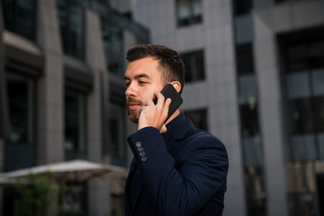Confident young entrepreneur talking by phone.