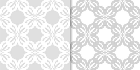 Light gray floral backgrounds. Set of seamless patterns