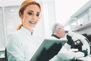 Pretty bioengineer. Pretty promising bioengineer feeling motivated smiling while working hard in...