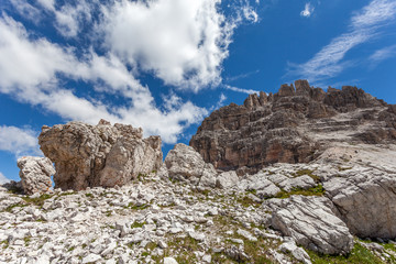 Large boulder at the foot of beautiful dolomitic pinnacles, Mount Paterno, Dolomites, Italy