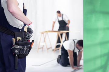 Close-up of craftsman with toolbelt during home renovation work