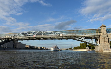Pushkin (Andrew) pedestrian bridge and the Moscow river with pleasure boats.