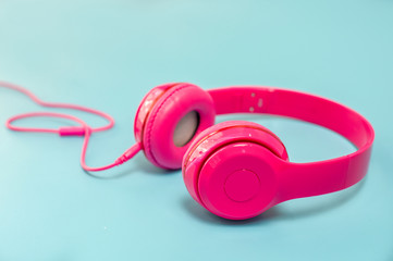 pink headphone on light Blue background,vintage or pastel concept