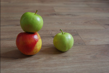 Three apples on wooden surfase