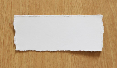 torn paper texture on wood background, copy space.