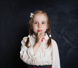 Fototapeta premium Schoolgirl Thinking. Back to School, Kid Creativity and Brainstorming Concept