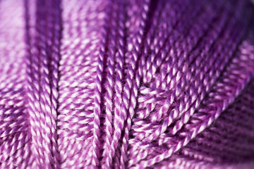 Extreme closeup of purple wool yarn.