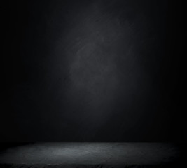 Dark room with tile floor and brick wall background