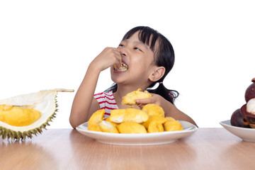 Asian Chinese little girl eating durian fruit