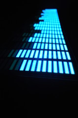 Luminous panel of pixels, with neon blue with green color and an equalizer on a black background