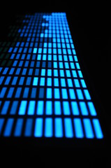 Luminous panel of pixels, with neon blue with green color and an equalizer on a black background