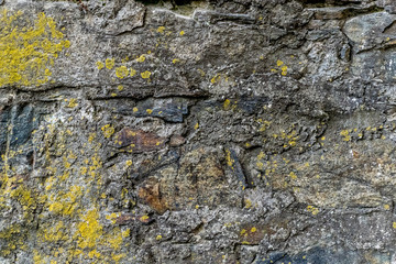 Verwitterte alte Steinmauer als Hintergrundstruktur