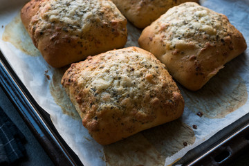 Freshly Baked Square Garlic Bread with Cheese and Herbs in Oven Tray.