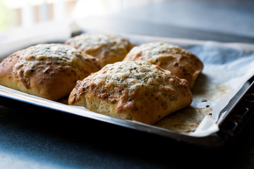 Freshly Baked Square Garlic Bread with Cheese and Herbs in Oven Tray.