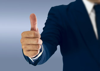 Businessman standing and thumbs to express preferences.