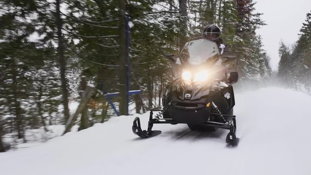 Snowmobile blazing through the trail in Qu&eacute;bec, Canada.