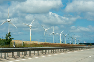 Fototapeta na wymiar Large view on the windmills on the field