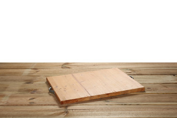 chopping board on a wooden table isolated on white background with clipping path and copy space