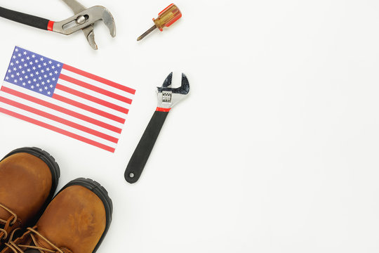 Table top view aerial image of decoration the sign of USA labor day on Sep 3,2018 background concept. Flat lay accessories tools and US flag and clothing for worker on modern rustic white wooden.