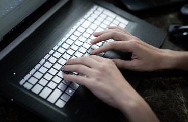 Hands typing on keyboard