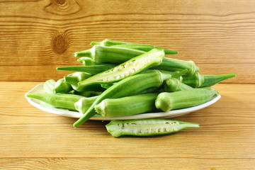 fresh okra vegetable in wooden table background