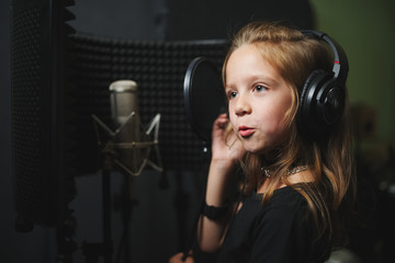 little girl singing in recording studio
