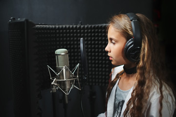 little girl singing in recording studio