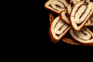 fresh appetizing strudel with cinnamon, sliced on a black background