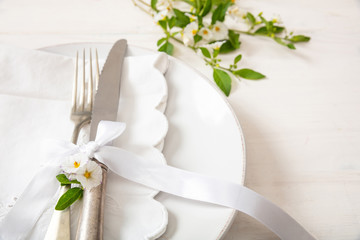 Holiday table place setting with plates, fork and knife