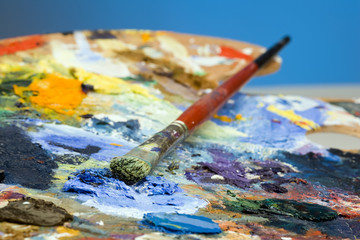 An artists paint palette and brush