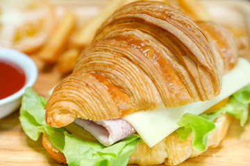 Croissant ham cheese delicious breakfast on wooden table