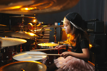 boy plays drums in recording studio