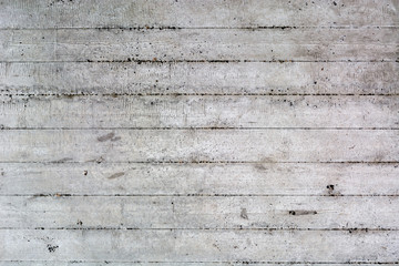 An old surface of concrete with impressions of rough boards. Gray industrial background. Copy space.