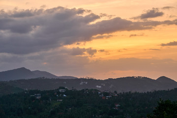 Colourful sunset over mountains and forest on a tropical island     