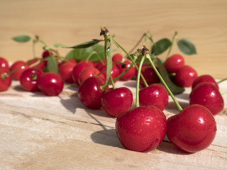 fresh cherry group with leaves on wooden table