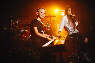 children singing and playing music in recording studio