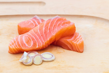Salmon fillet  and lemon grass in the wooden plate.